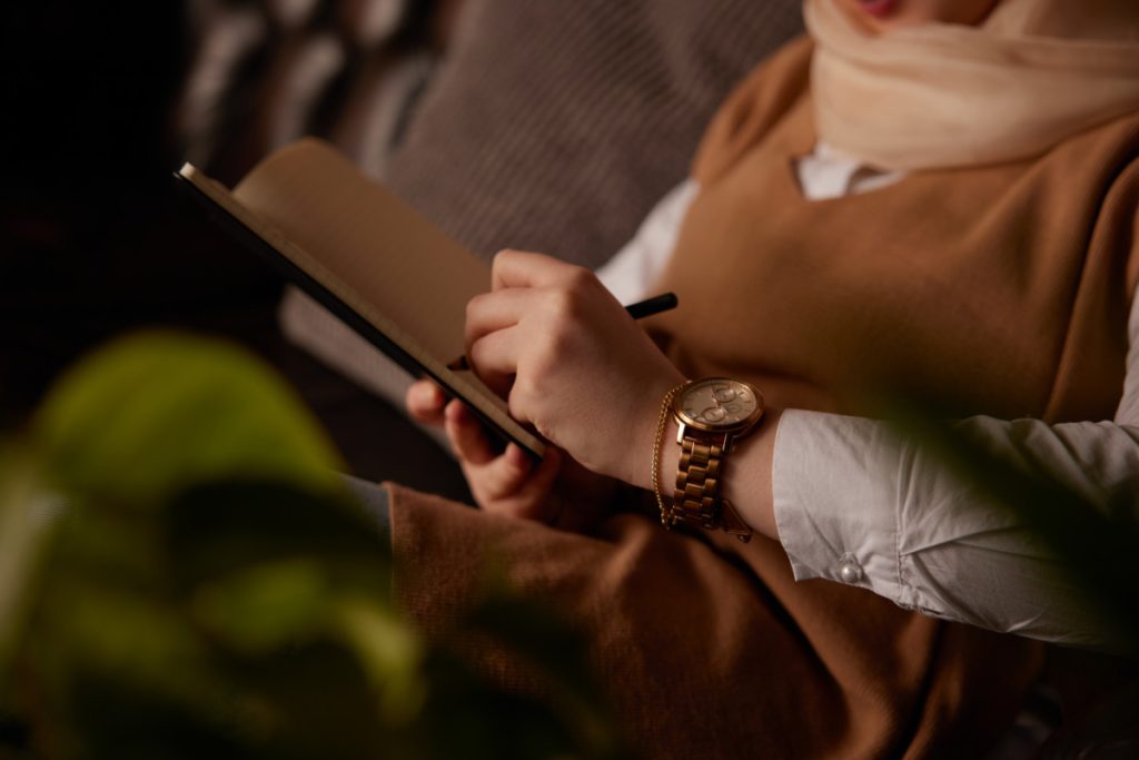 A person writing notes on a clipboard